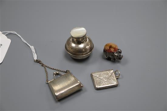 A miniature 925 purse. a silver pig pin cushion, marks rubbed, a 925 envelope stamp case and an Edwardian scent flask,